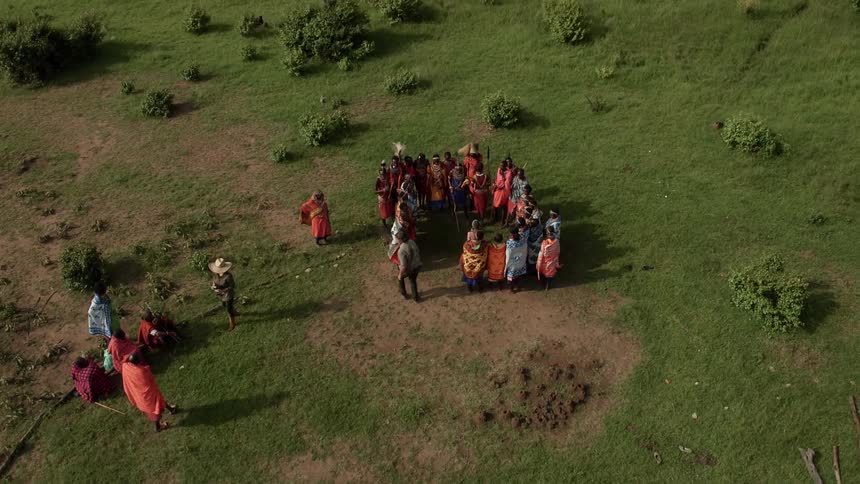 Photographers wander between maasai gathered outdoors