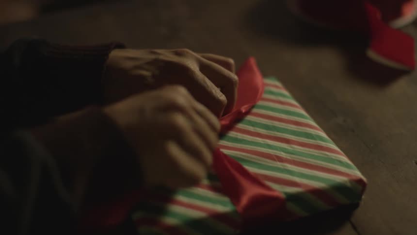 A woman is wrapping a present