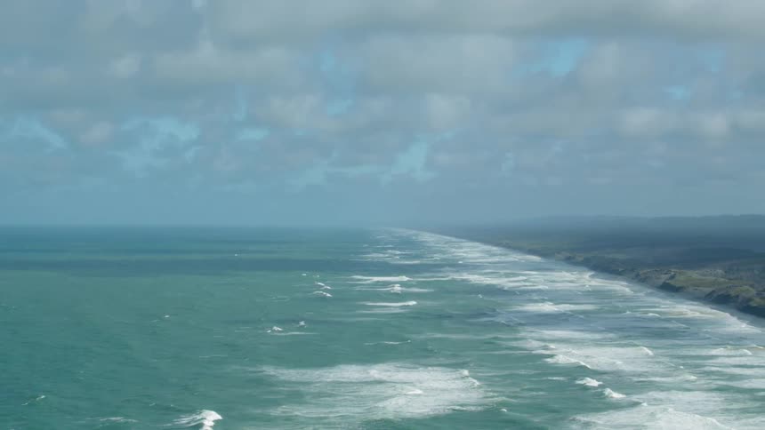 Waves flow onto the beach shore