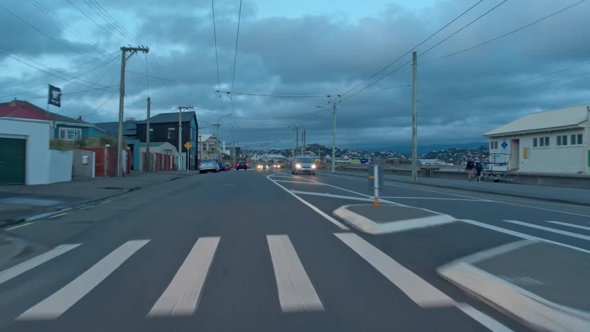 Vehicles travel on a road through the town