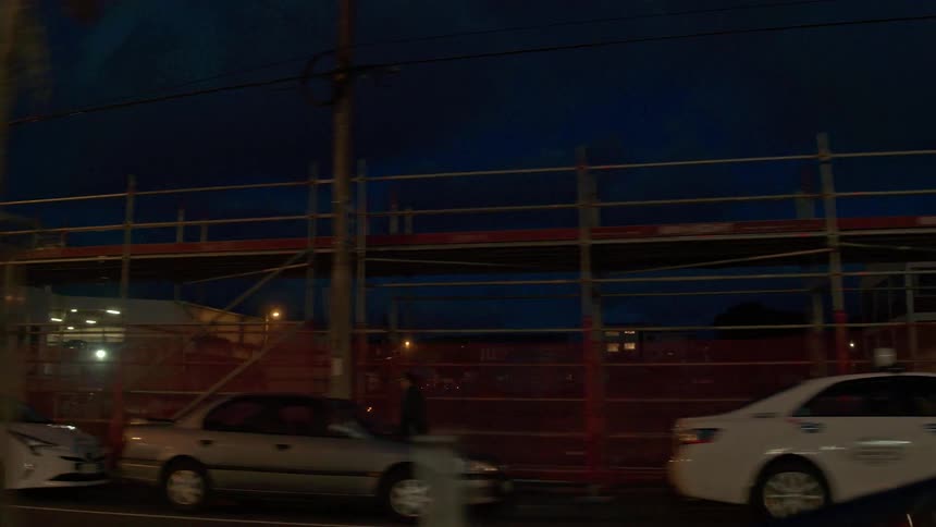 Vehicles travel on a city road at night