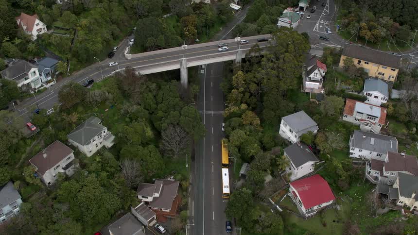 Vehicles travel on the roads near houses