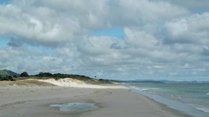 Waves flow onto the beach shore