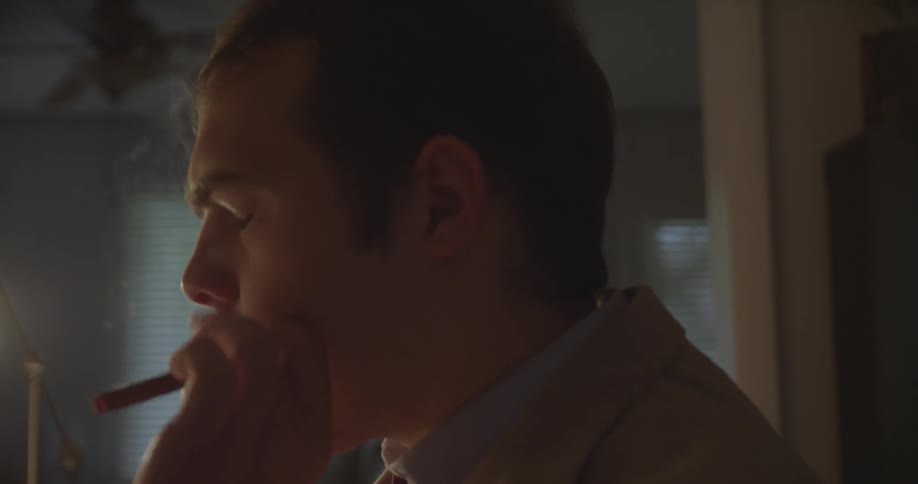 A man is smoking a cigar