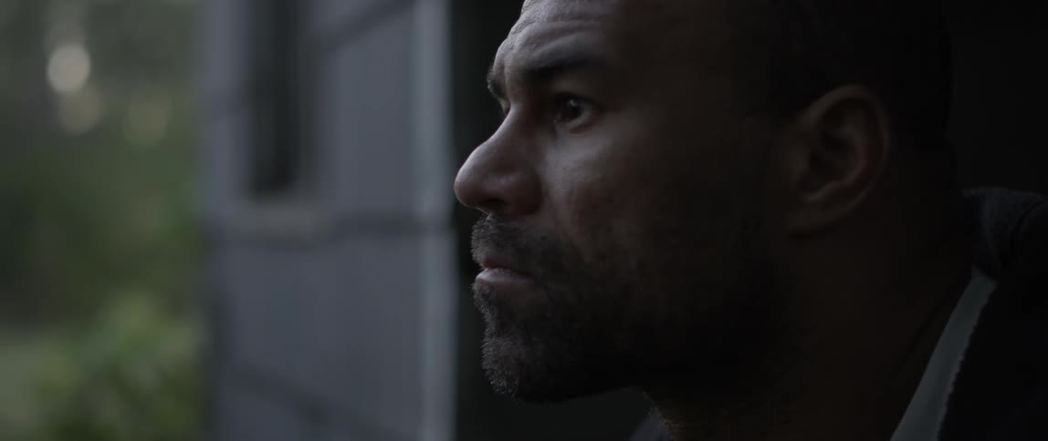 A man stares intently outside
