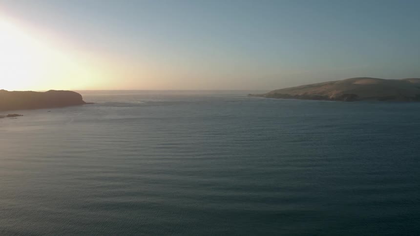 The sun is setting over the lake ahead