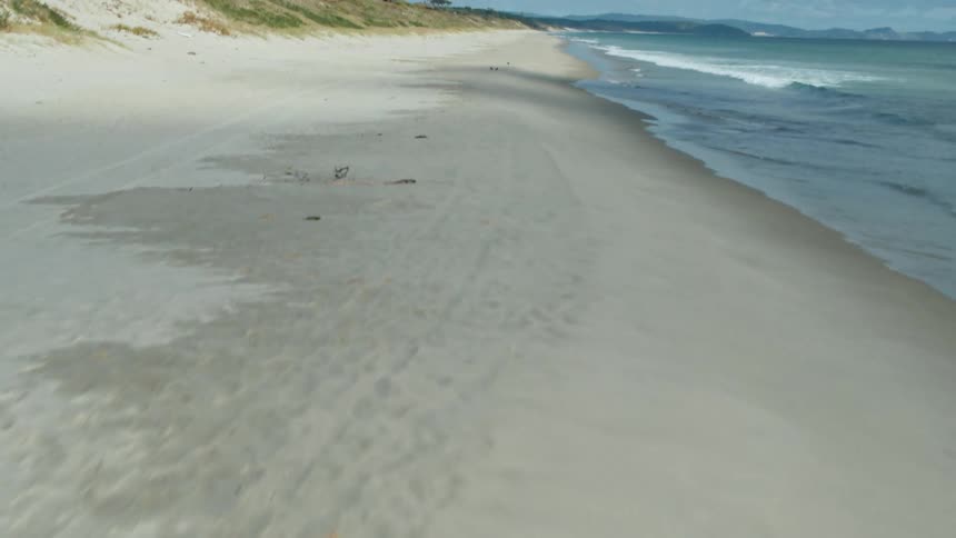 Waves flow onto the beach shore