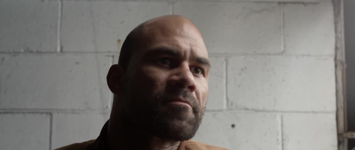 A man is leaning against the window then walks off