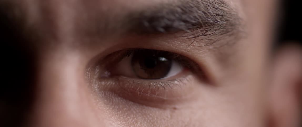 Man's eye looking directly into a lens