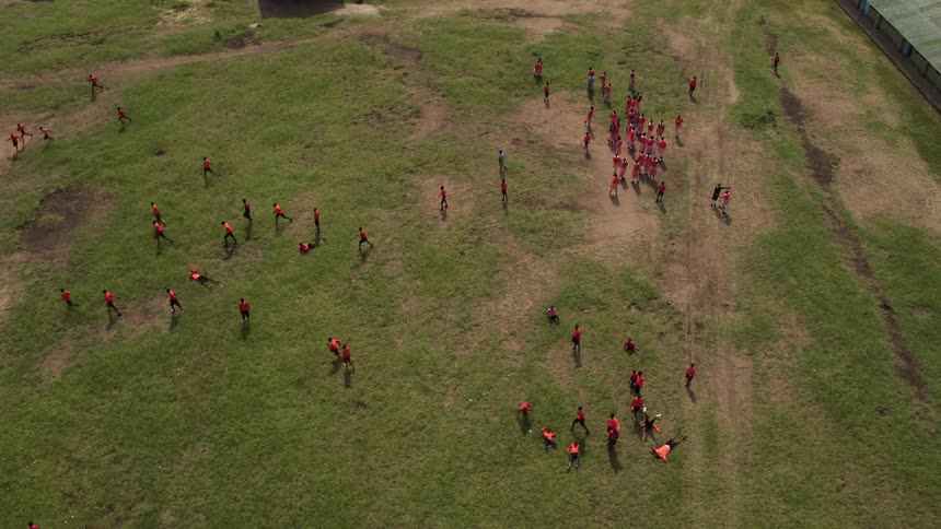 School children play in a field