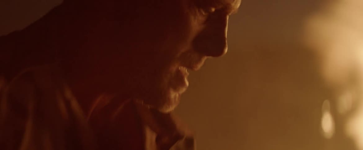 A man attempts to extinguish a fire