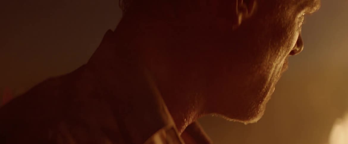 A man is looking at a large fire