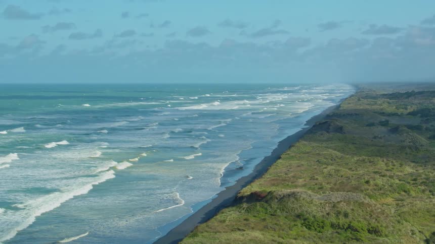 Waves flow onto the beach shore