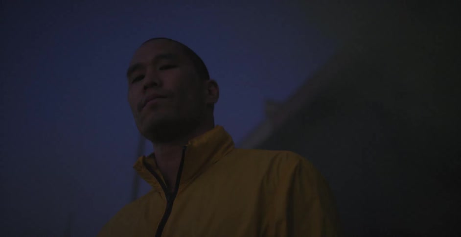 A man stands outside at night