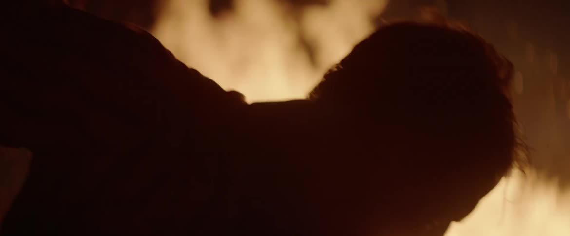 A man desperately tries to extinguish a fire