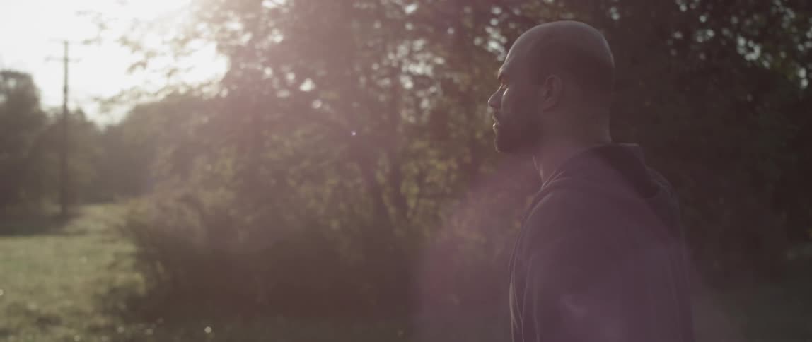 A man walks outside in the sun