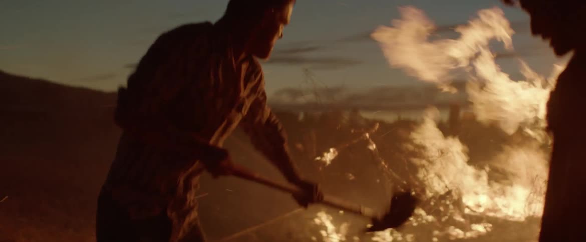 Two men attempt to extinguish a fire