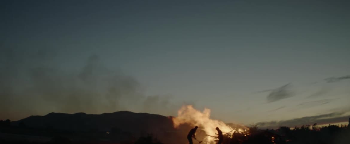Two men attempt to extinguish a fire