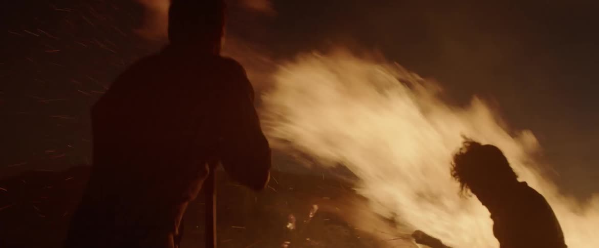 Two men attempt to extinguish a fire