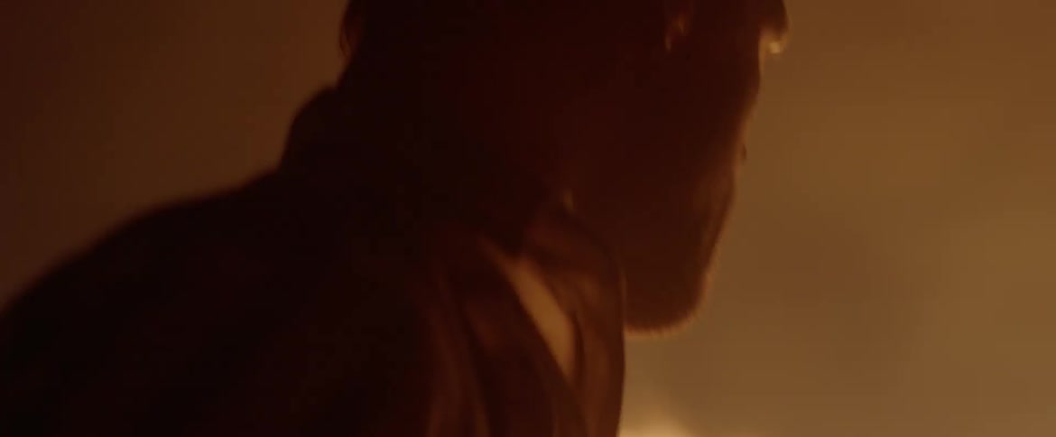 A man frantically attempts to extinguish a fire