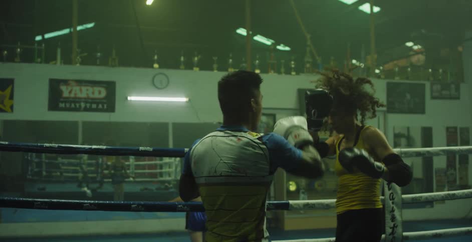 Man and woman box in a boxing ring
