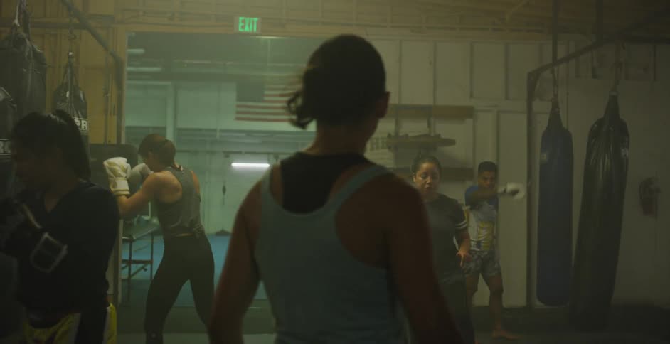 Women train sparring in a gym