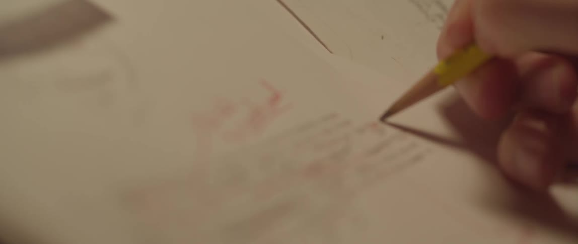 A person edits with a pencil
