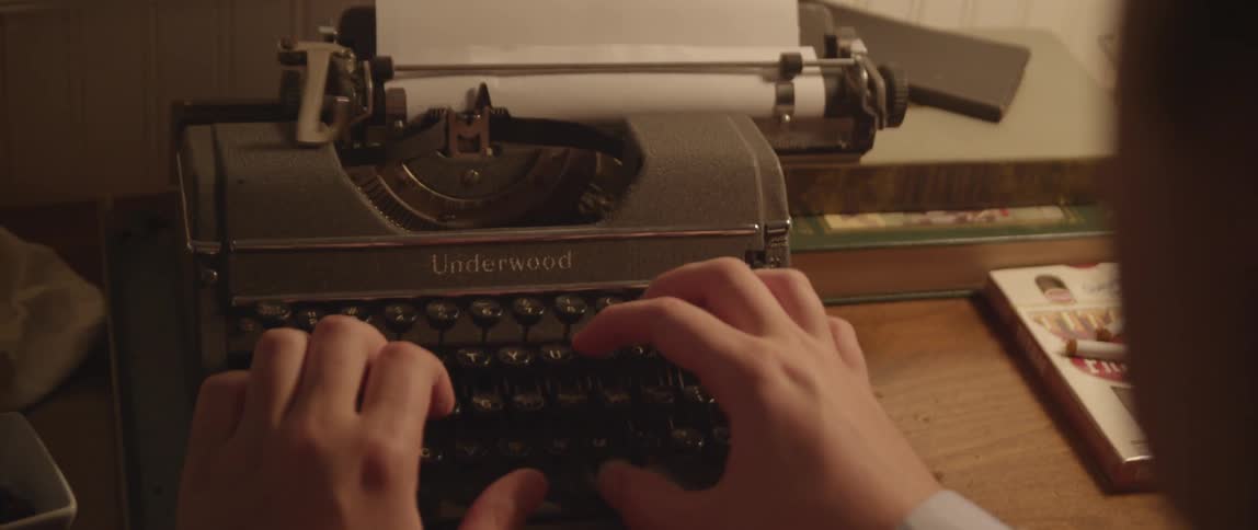 A person typing on a typewriter