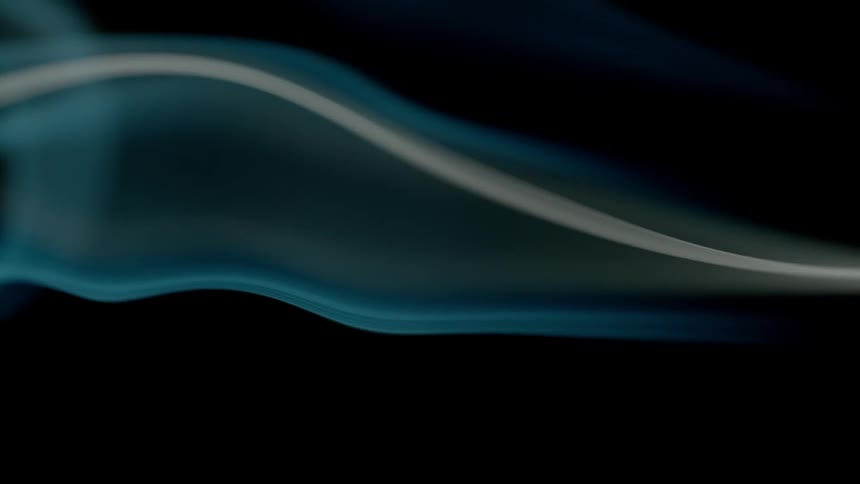 The smoke from a flame is moving in the dark