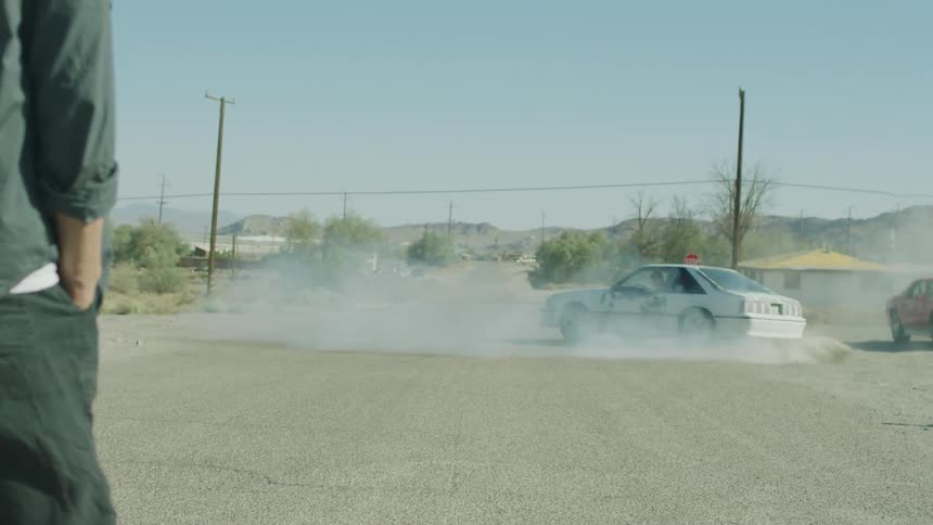 A ford mustang does donuts in the street