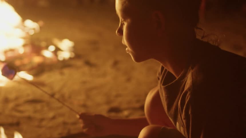 A young man roasts a marshmallow