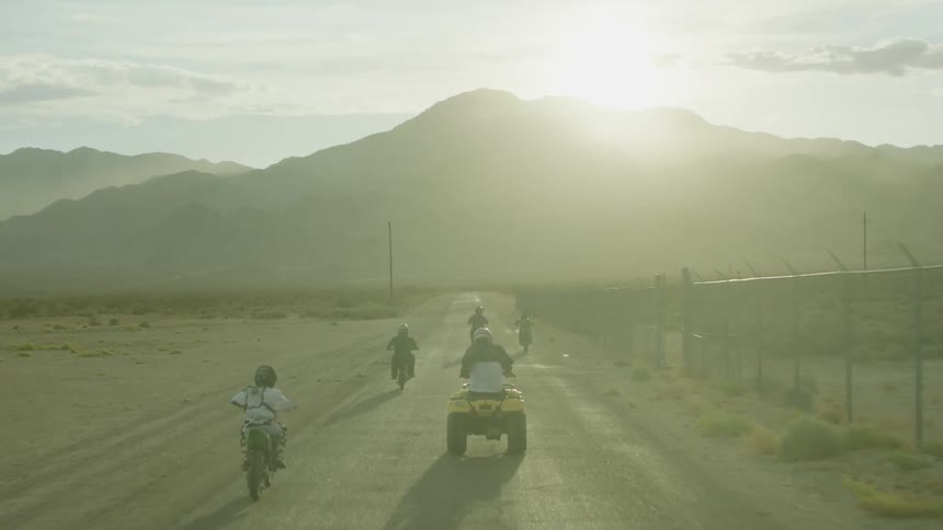 A group of people ride on off road vehicles