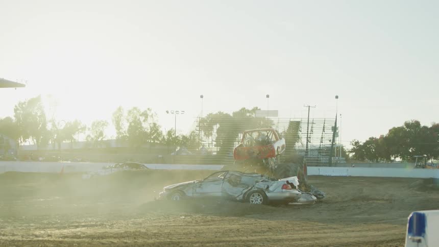 Monster truck rolling over broken cars