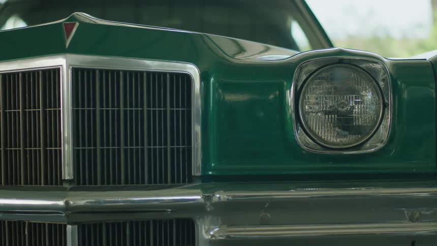 A green car sits motionless
