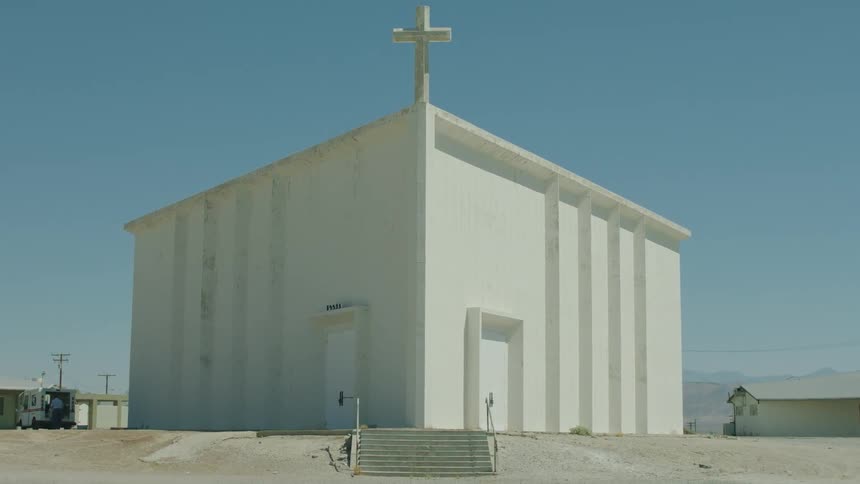 A church sits idle in a desert town on a sunny day