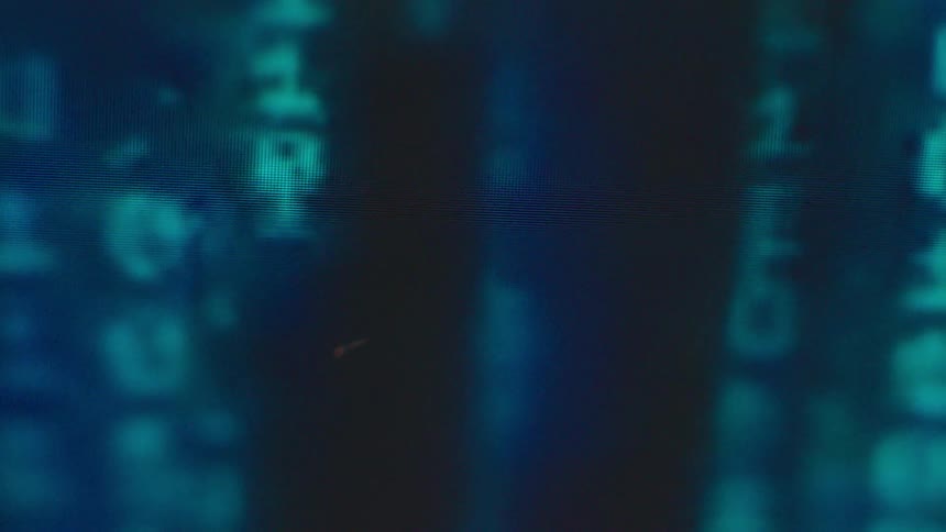 Binary code is displayed on a screen