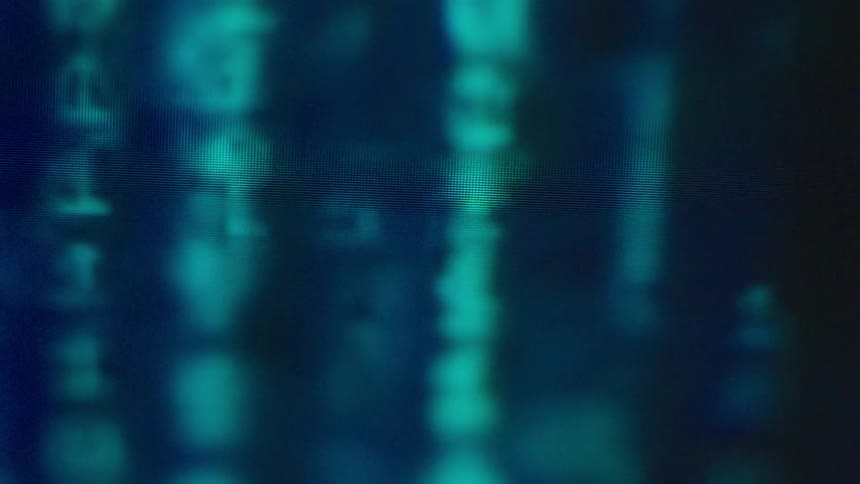 Binary code is displayed on a screen