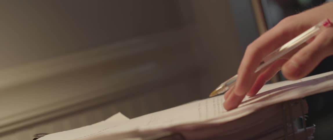 Person grading papers with red pen