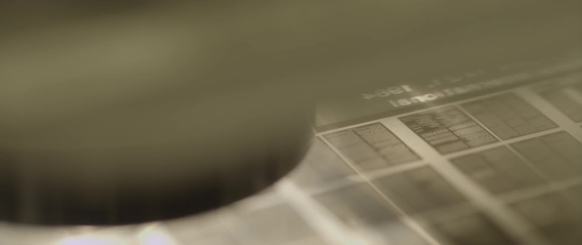Watching as microfiche slides underneath a viewer