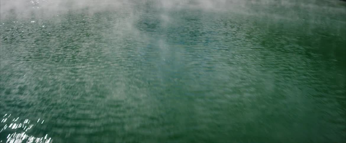 Steam pours from a hot spring