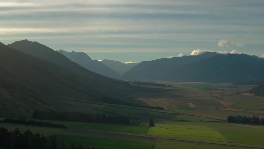 Clouds float over a mountain valley