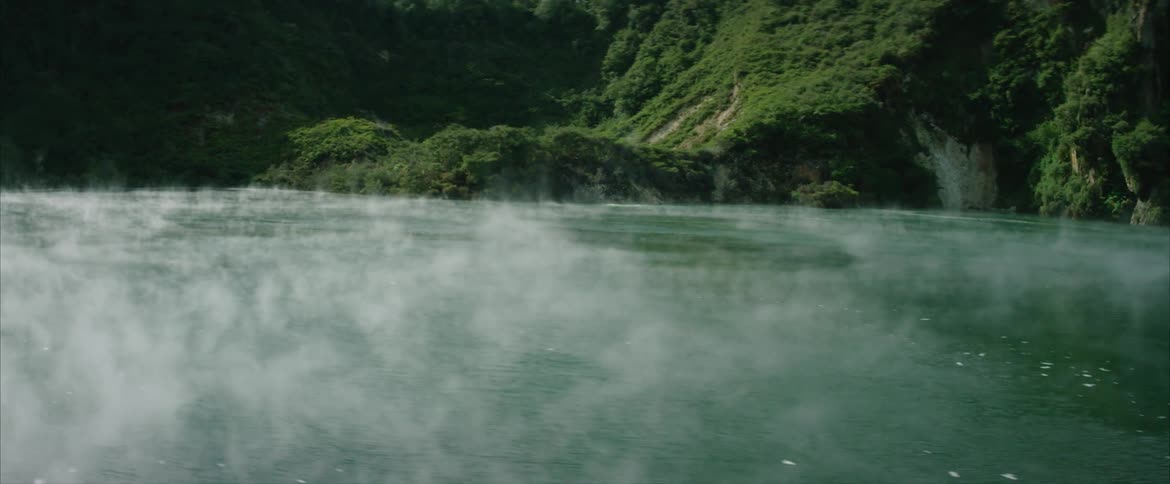 Steam pours from a hot spring