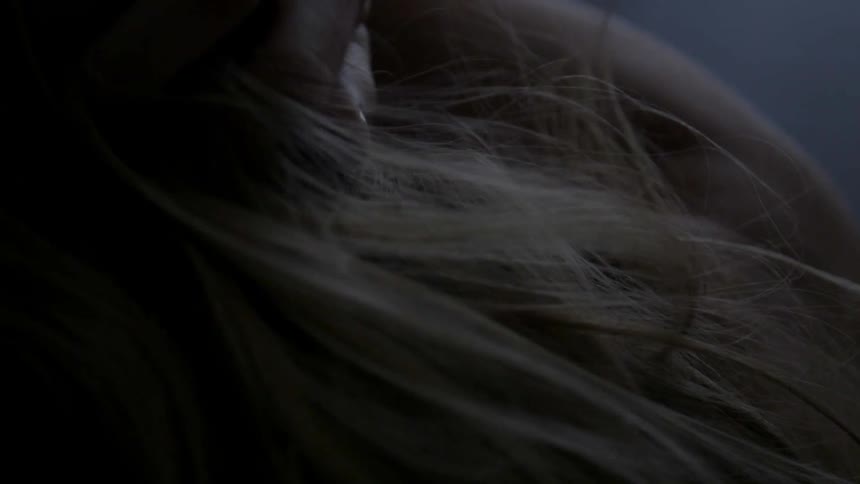 Woman's hair in a dim room