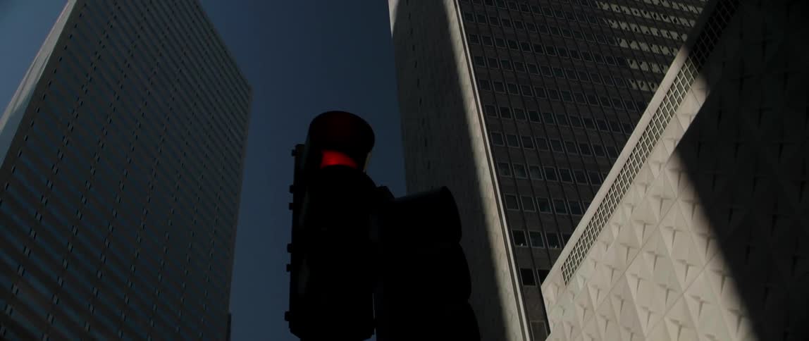 A street light is bright red on a street corner