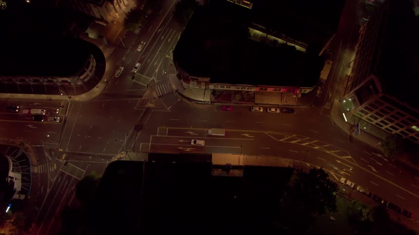 Vehicles travel on a city road at night