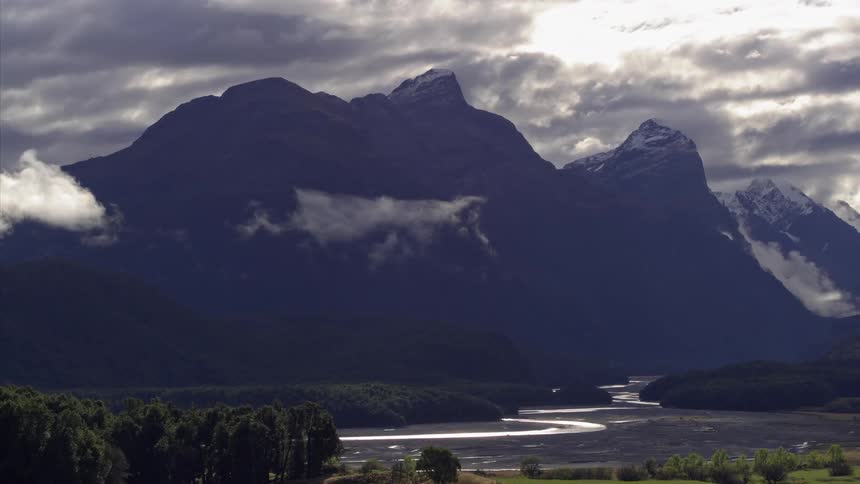 Clouds hover near mountain peaks