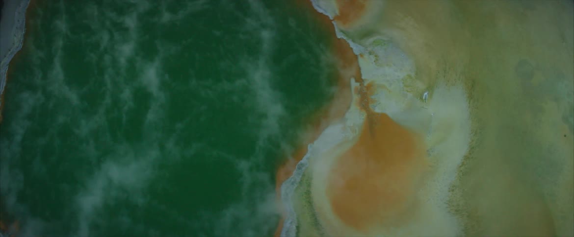 Steam pours from a hot spring