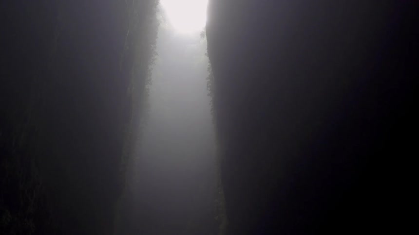 Rain falls into a cavern