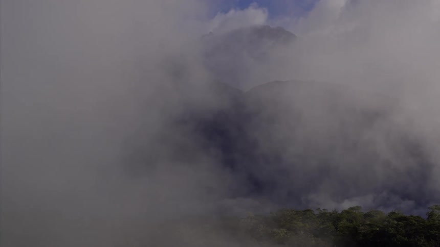 Steam pours out of a mountain top