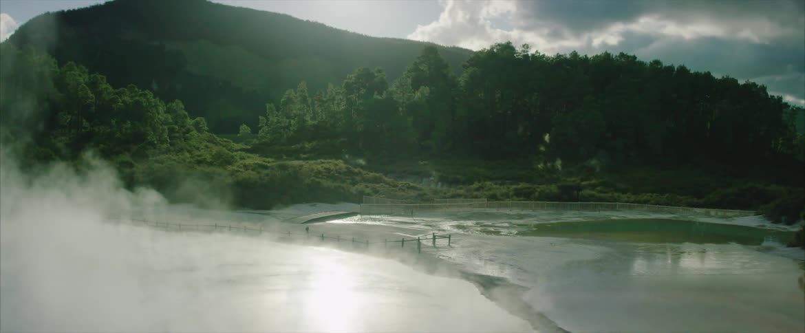 Steam pours from a hot spring